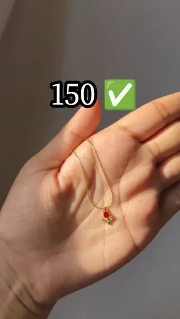 Anjal's red rose pendant on a palm