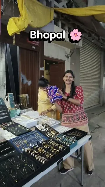 A customer picking jewellery at the stall